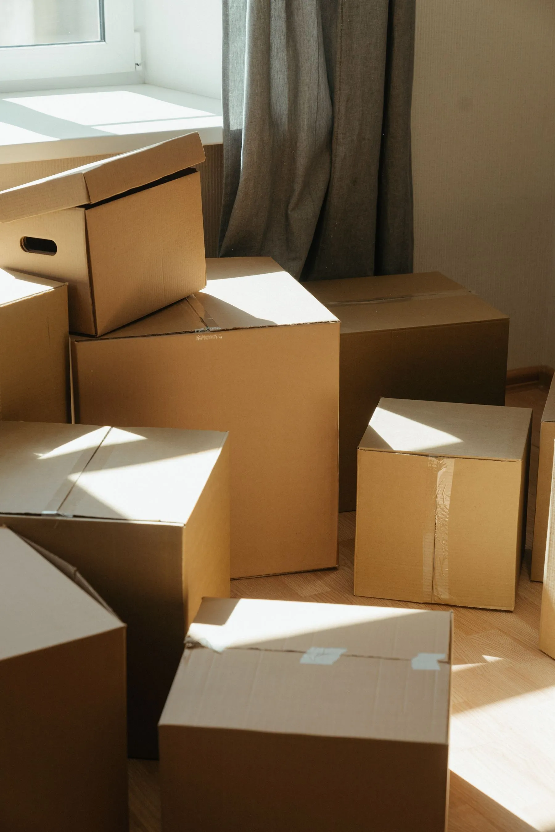 Neatly stacked moving boxes in a sunlit Berlin apartment